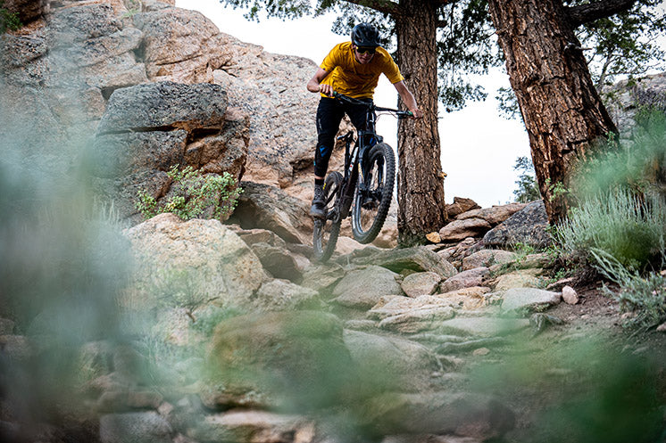 Joe jumping bike off large rock drop