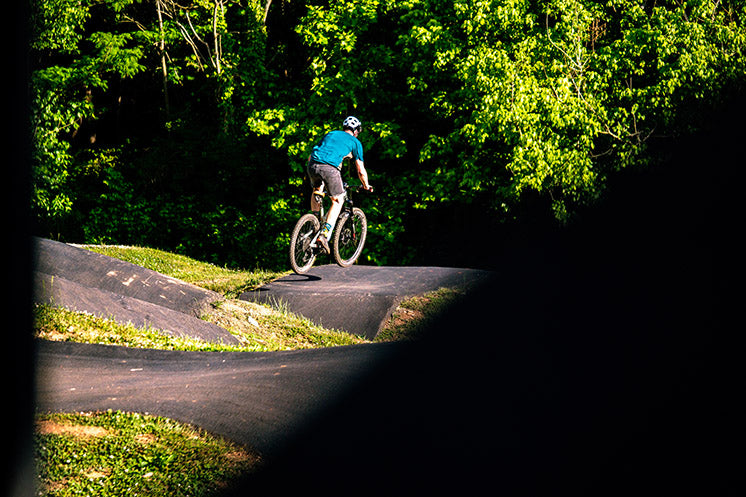 Julian riding roller on paved pump track