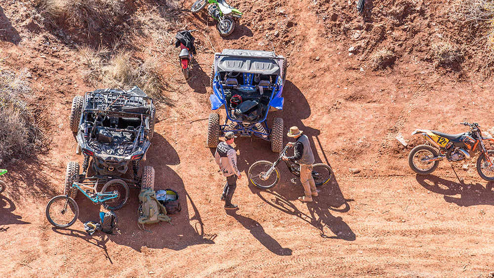 Riders shuttle rigs and dirt bikes lined up for battle